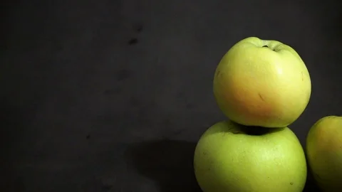 Green apples on a black background. fruit on black background. scattered apples. Stock Footage 99400932
