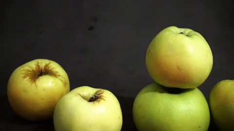 Green apples on a black background. fruit on black background. scattered apples. Stock Footage 99400944