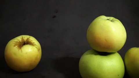 Green apples on a black background. fruit on black background. scattered apples. Stock Footage 99400945