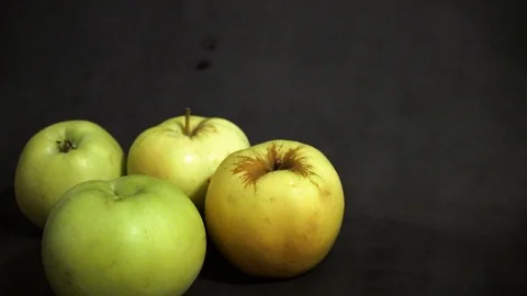 Green apples on a black background. fruit on black background. scattered apples. Stock Footage 99400960