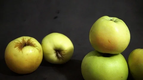 Green apples on a black background. fruit on black background. scattered apples. Stock Footage 99400962