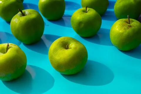 Green apples on blue background, fruits Stock Photos