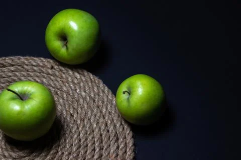 Green apples on a dark background. Fruit theme Stock Photos