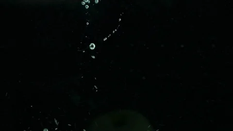 Green apples fall into clear water with big bubbles and splashes Stock Footage 125812647