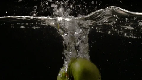 Green apples fall into water one by one close-up slow motion Stock Footage 91503989