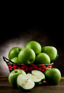 Green apples inside a basket Stock Photos
