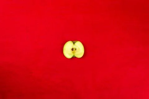 Green apples on a red background Stock-Fotos