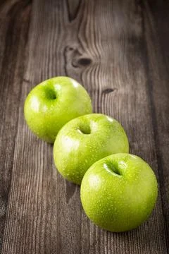 Green apples on the table. Stock Photos