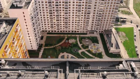 Green area of the courtyard of an apartment complex. Drone footage Stock Footage 223143020