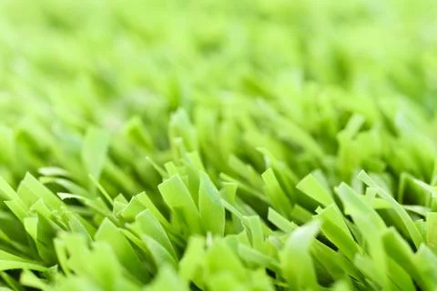 Green artificial grass texture with blurred background. Modern soft tender ba Foto stock