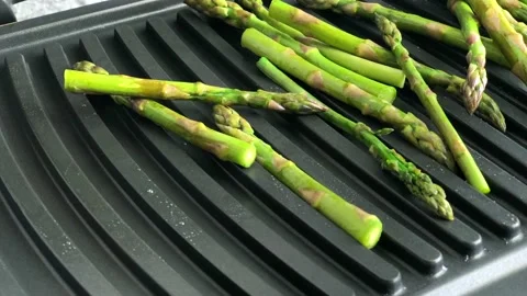 Green asparagus on grill Stock Footage 130591790