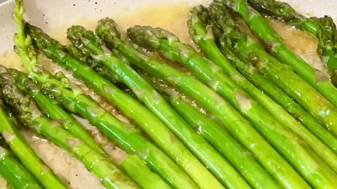 Green asparagus large pan caramelization asparagus with sugar salt butter Stock Footage 309533715