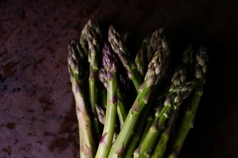 Green Asparagus on rustic background Stock Photos