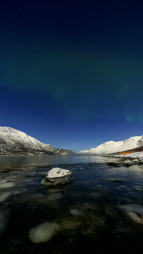 Green Aurora Borealis Time Lapse Over Snowy Land and Mountain Stream Stock Footage 345876082