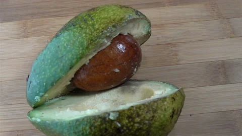 Green avocado cut in half with a pit in 4K Stock Footage 123289172