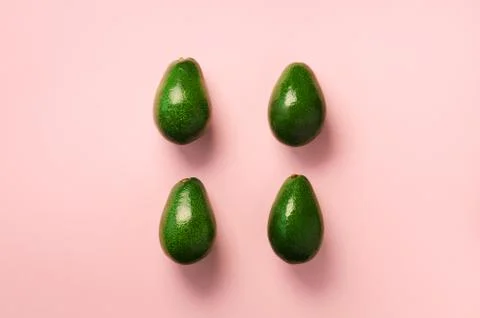 Green avocado pattern on pink background. Top view. Pop art design, creative 스톡 사진