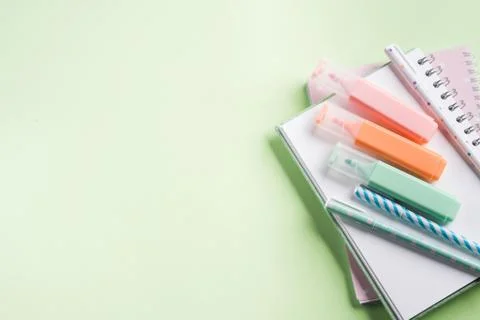 Green back to school flat lay with pastel stationery Stock Photos