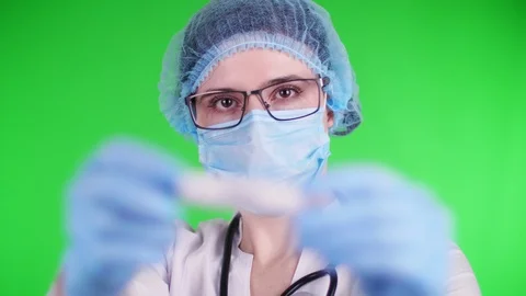 Green background. close-up, doctor's hands in blue medical gloves holds test Stock Footage 125163222
