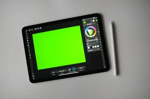 Green background for digital drawing on tablet. Remote creative freelance work. Stock-Fotos