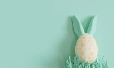 Green background with Easter egg, rabbit ears and copy space. Easter backdr.. Stock Photos