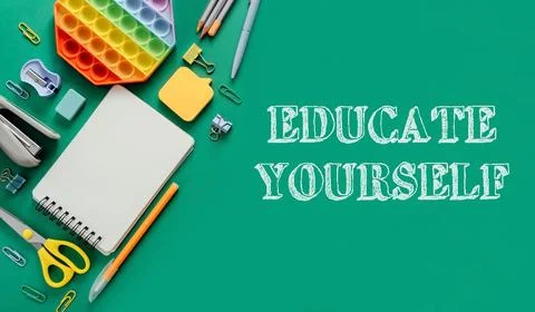 A green background with a notebook, pens, scissors, and a stress ball Foto stock