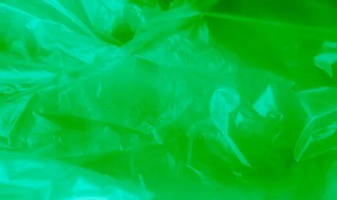 Green background plastic wrinkle bag film glossy crumpled overlay package Stock Photos