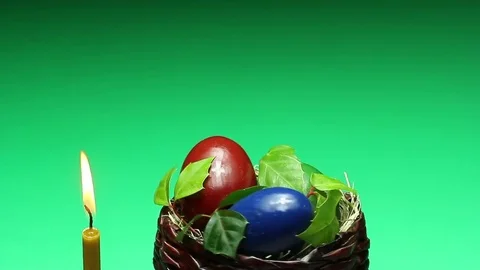 On a green background revolves wicker basket with Easter eggs 動画素材 73015492