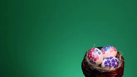 On a green background revolves wicker basket with hand-painted Easter eggs 動画素材 73109255
