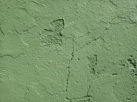 Green background with a rough, cement-like texture. Stock Photos