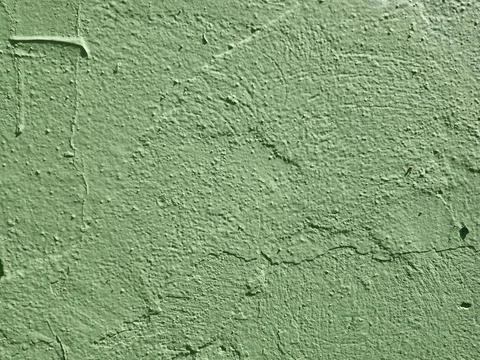 Green background with a rough, cement-like texture. Stock Photos