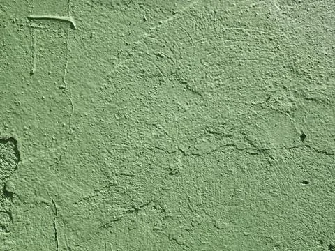 Green background with a rough, cement-like texture. Stock Photos