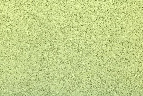 Green background of structural plaster with fine grains Stock Photos