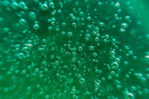 Green background, texture with bubbles in some liquid. Stock Photos