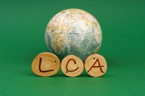 On a green background there is an Earth globe and wooden roundels with the .. Stock Illustration