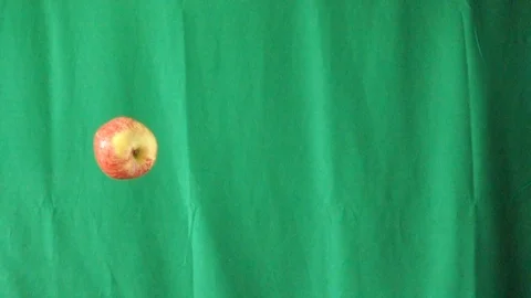 Green background video slow motion, Throw one apple up to the top. Stock Footage 108727671