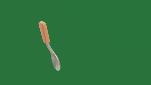 A green background with white and orange object pair of scissors on spoon an Stock Footage 335937548