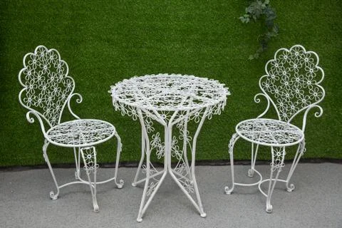 Green background, white round table, white chair, large white flower. Henna a Stock Photos