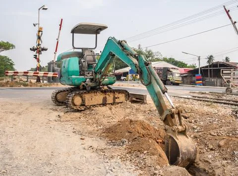 Green backhoe dredging soil Stock Photos