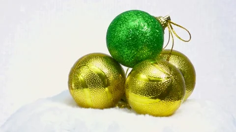 Green ball and three balls of yellow balls rotate on a white surface Video stock 160785247