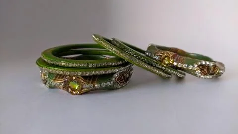 Green bangles isolated on white background - wedding  Traditional gold bangle Stock Photos