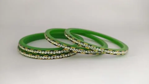 Green bangles isolated on white background - wedding  Traditional gold bangle Stock Photos