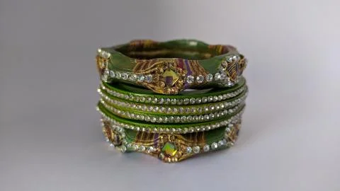 Green bangles isolated on white background - wedding  Traditional gold bangle Stock Photos