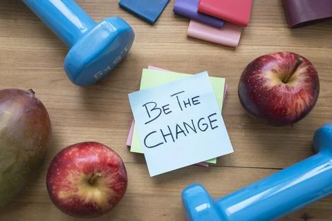 Green Be the Change Sticky Note Surrounded by Fresh Fruit and Fitness Acces.. Stock Photos