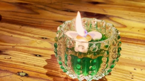 Green Beaded Candle On Wooden Table Stock Footage 337527273