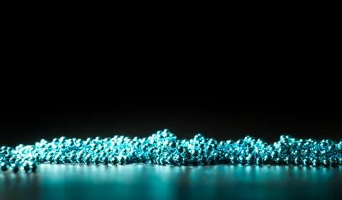 Green beads on a dark background, selective focus Stock Photos