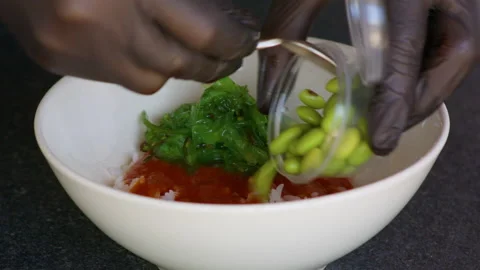 Green beans and kidney beans are served in a bowl of seaweed and ketchup. Video stock 158775384