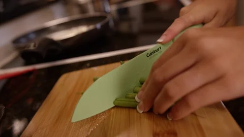 Green beans being chopped up and placed in sautee pan Stock Footage 124225285