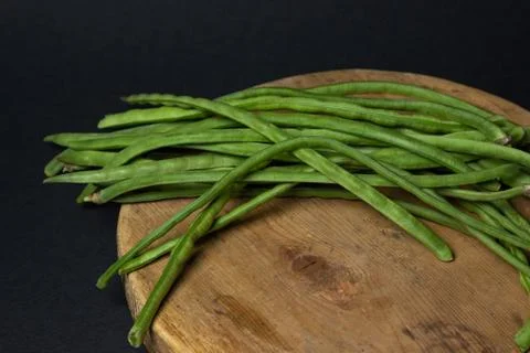 Green beans on a black background. Stock Photos
