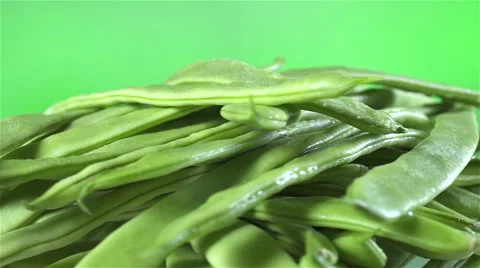 Green Beans isolated rotating on green background Stock Footage 62306275