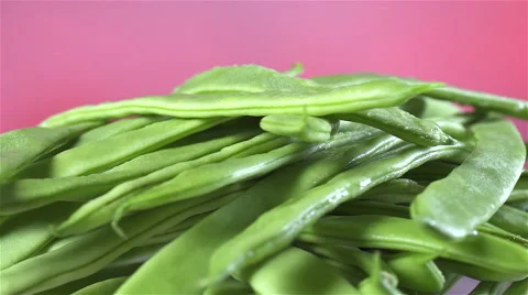 Green Beans isolated rotating on red/pink background Stock Footage 62306030